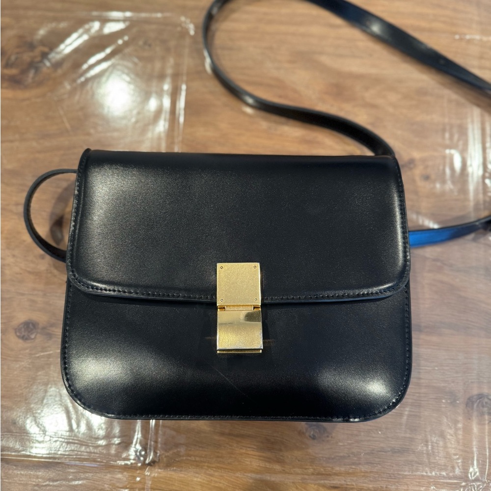 Black and gold cross body purse flap detail